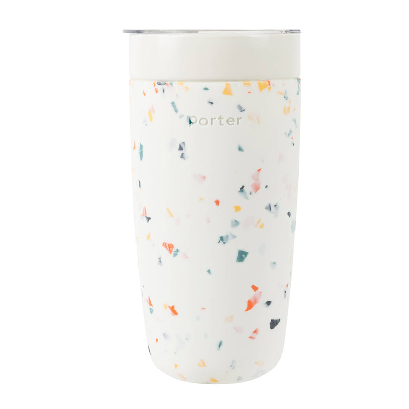Pink tumbler with multicolor speckled pattern on a white background