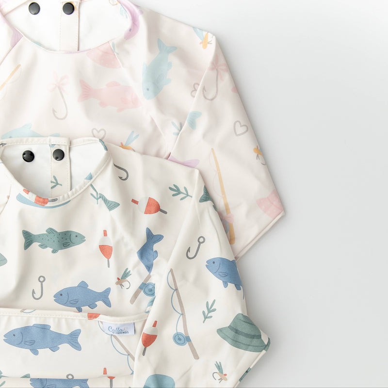 Baby bib with fish pattern on a cream background