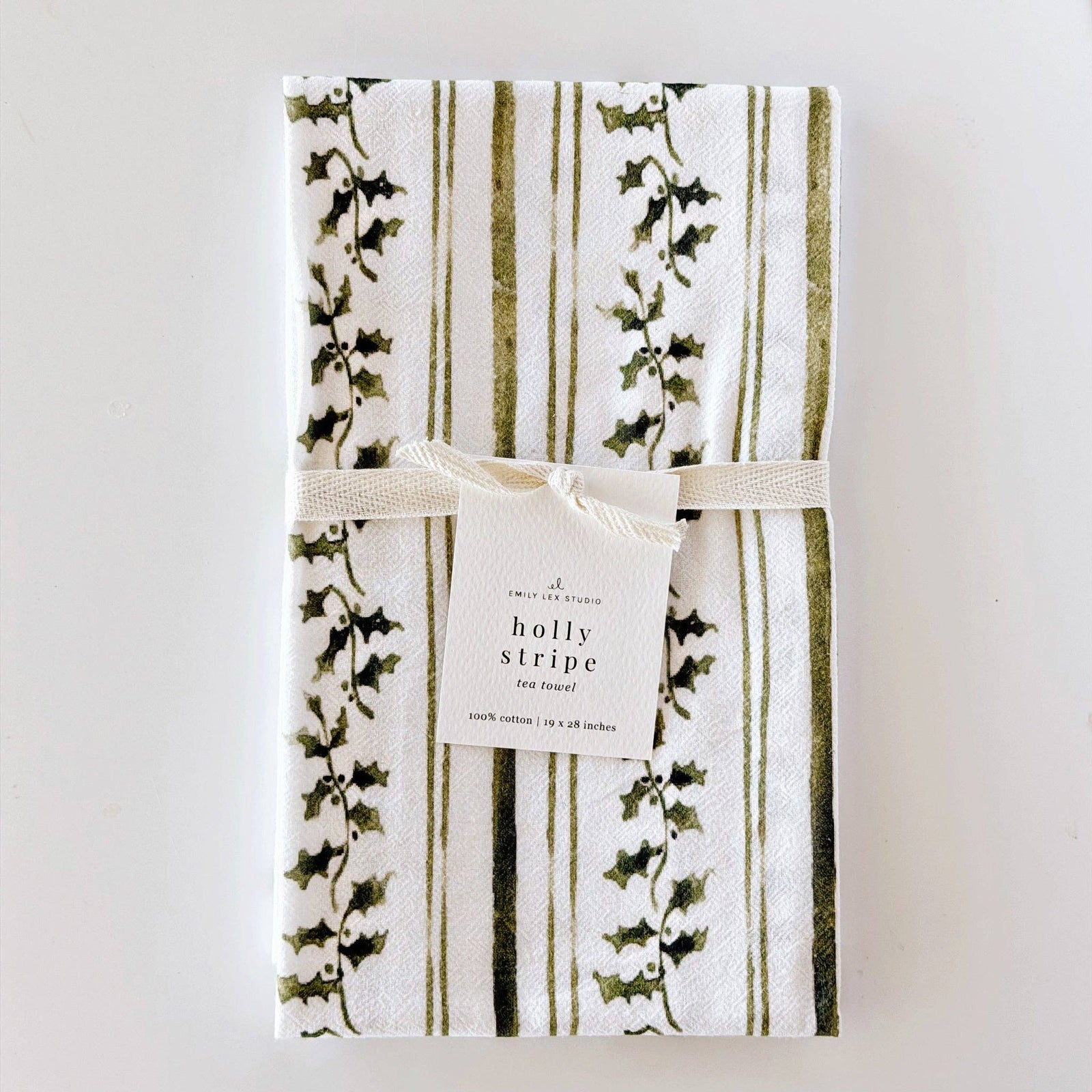 Packaged towel with holly stripe design on a white background