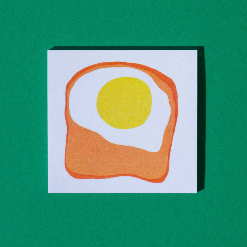 Sticky note pad with 'Egg & Toast It' design on a green background