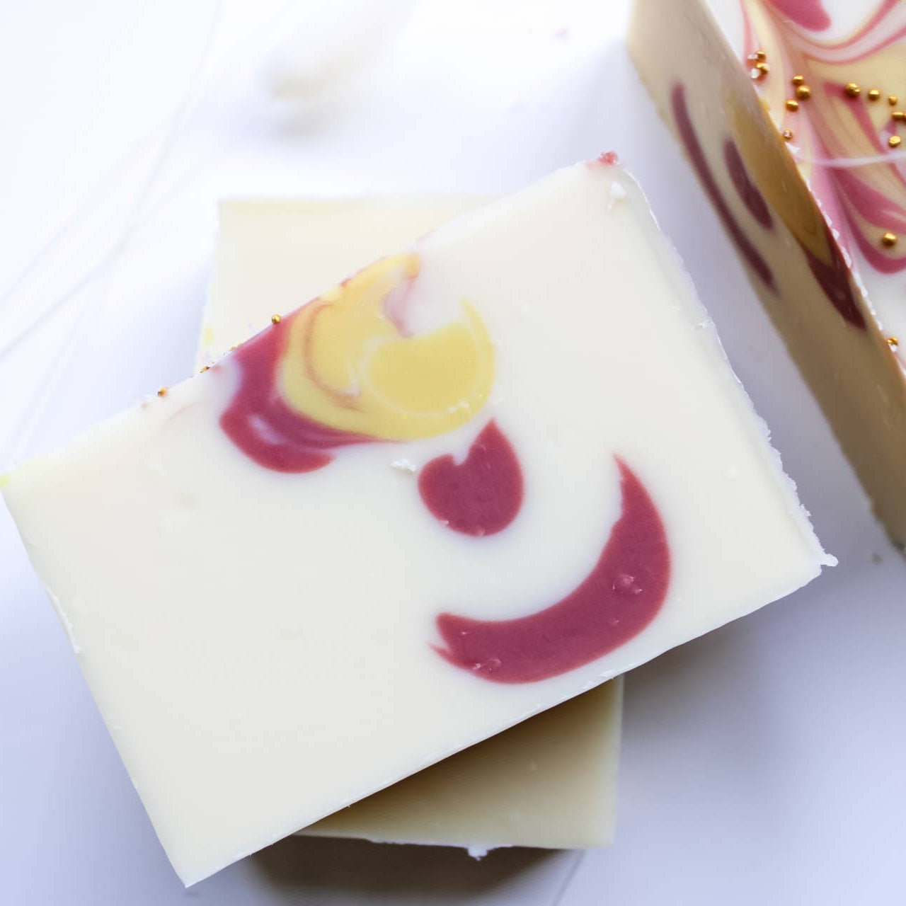 Decorative soap bars with colorful swirls on a white background
