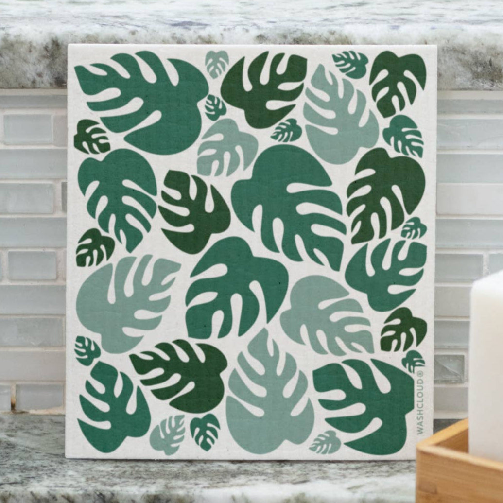 Decorative tile with green leaf pattern on a kitchen counter