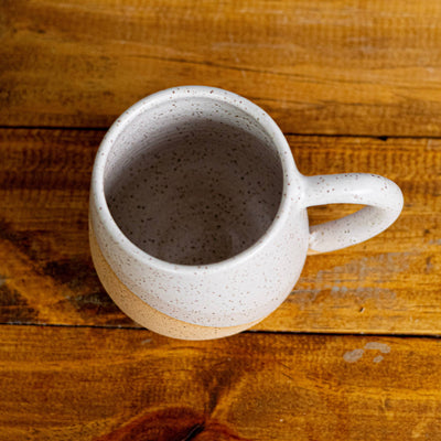 White ceramic mug on a wooden surface