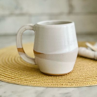 White ceramic mug on a woven placemat