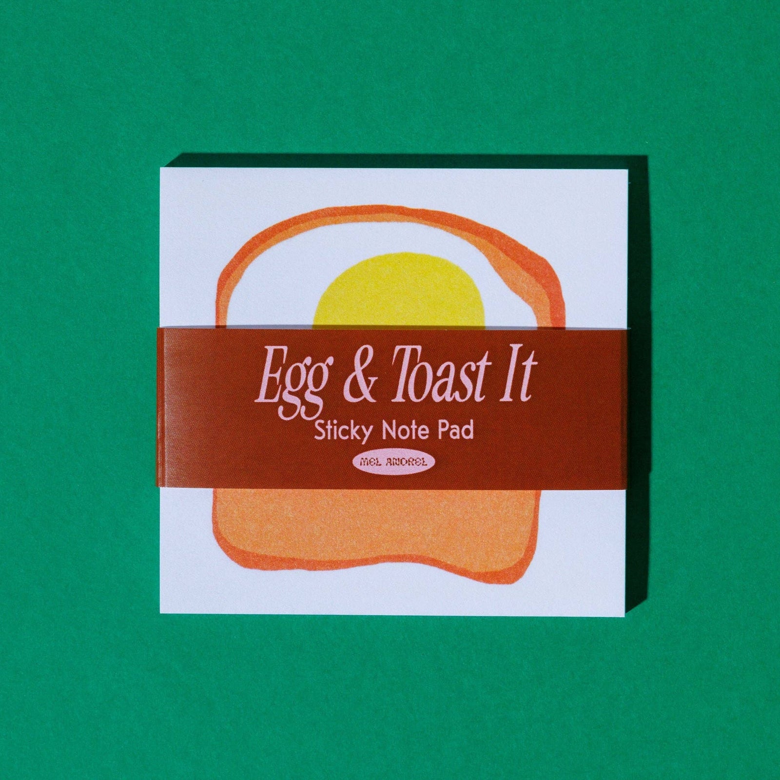 Sticky note pad with 'Egg & Toast It' design on a green background