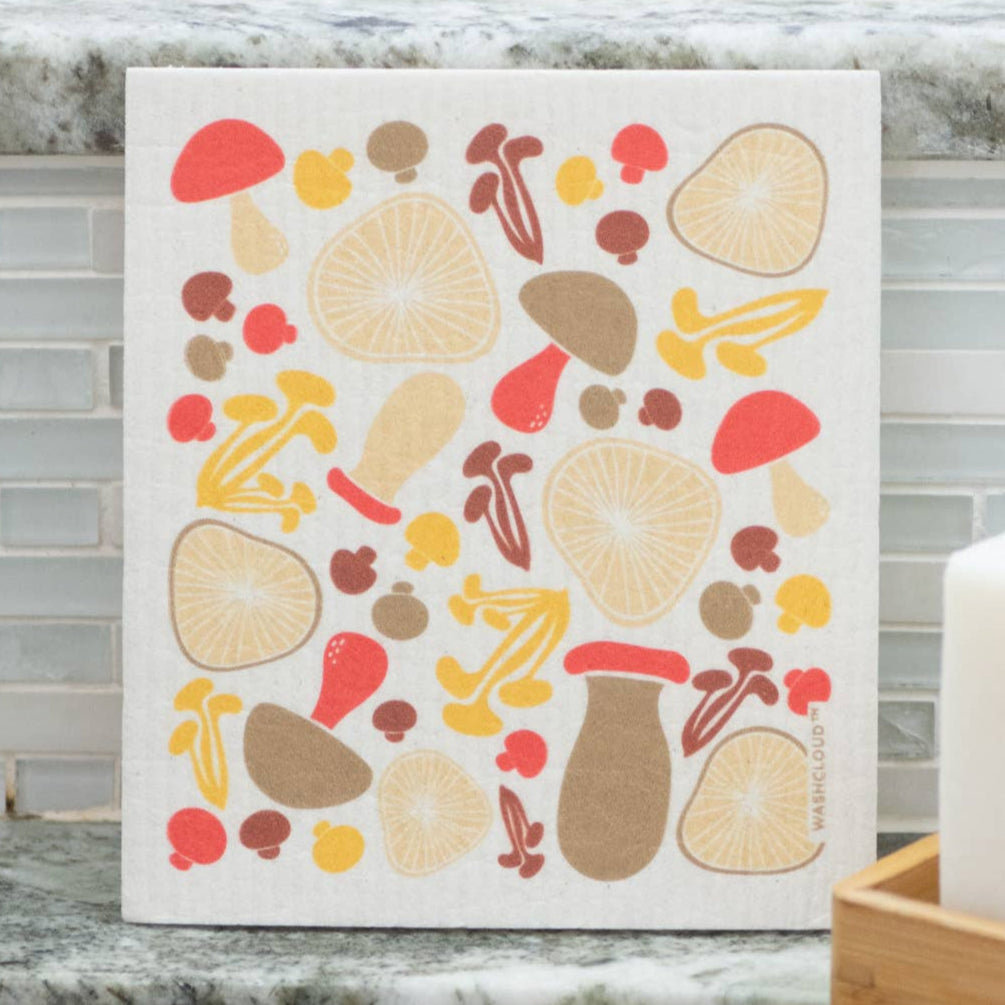 Decorative kitchen towel with autumnal design hanging on a kitchen wall.