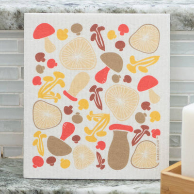 Decorative kitchen towel with autumnal design hanging on a kitchen wall.