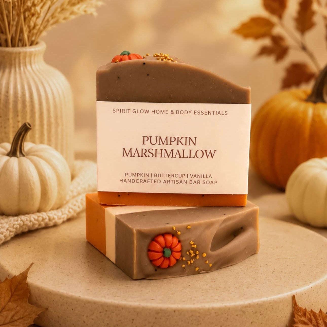 Pumpkin marshmallow soaps displayed artistically with pumpkins in the background. 