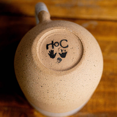 Ceramic mug with a logo on a wooden surface