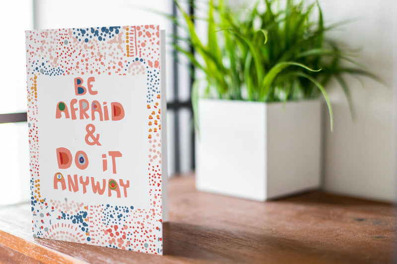Motivational card with 'Be Afraid & Do It Anyway' text on a white background