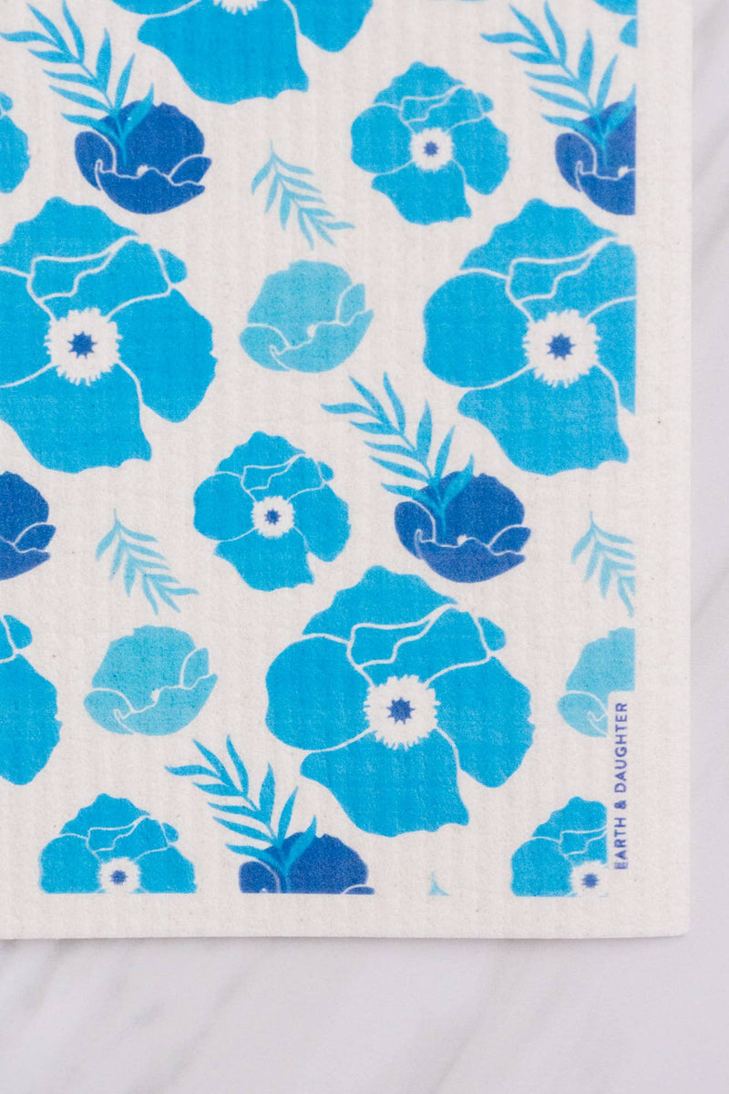 White cloth with blue floral pattern on a wooden surface