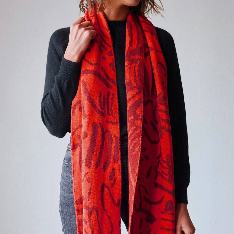Red scarf with abstract pattern on a white background