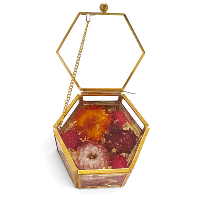Vintage style jewelry box with a chain lid and flowers in resin set on a white background.
