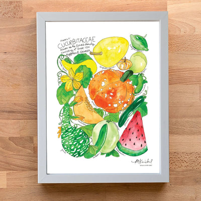 A framed watercolor art print featuring various cucurbits and fruits, displayed on a light wooden surface. The print includes a yellow melon, orange pumpkin, watermelon slice, and green melon with botanical text at the top, enclosed in a light gray frame.
