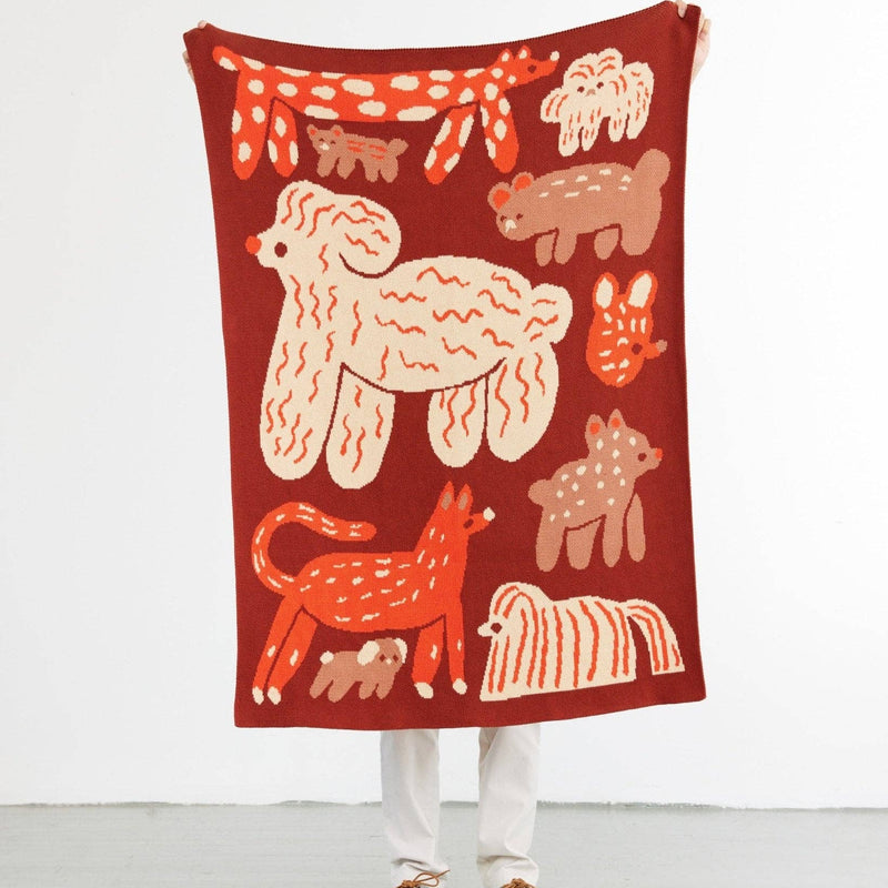 Children's blanket with animal illustrations on a red background
