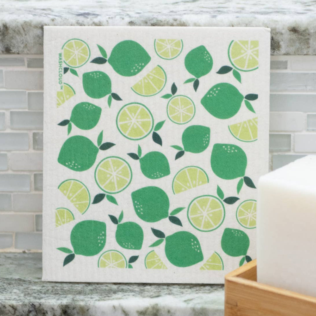 Dishcloth with green lemon pattern on a kitchen counter