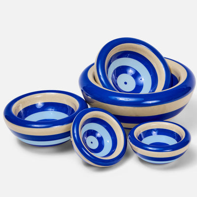 A set of ceramic bowls with concentric blue and beige spiral patterns, displayed on a clean white background.