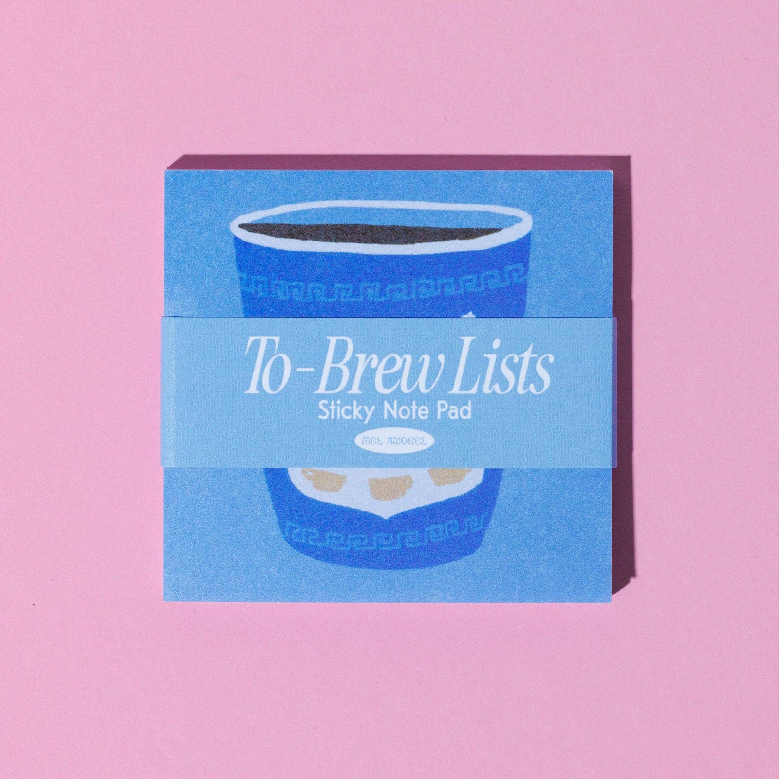 A square sticky note pad labeled 'To-Brew Lists' in white script, shown on a solid pink background. The pad features a blue coffee cup illustration 