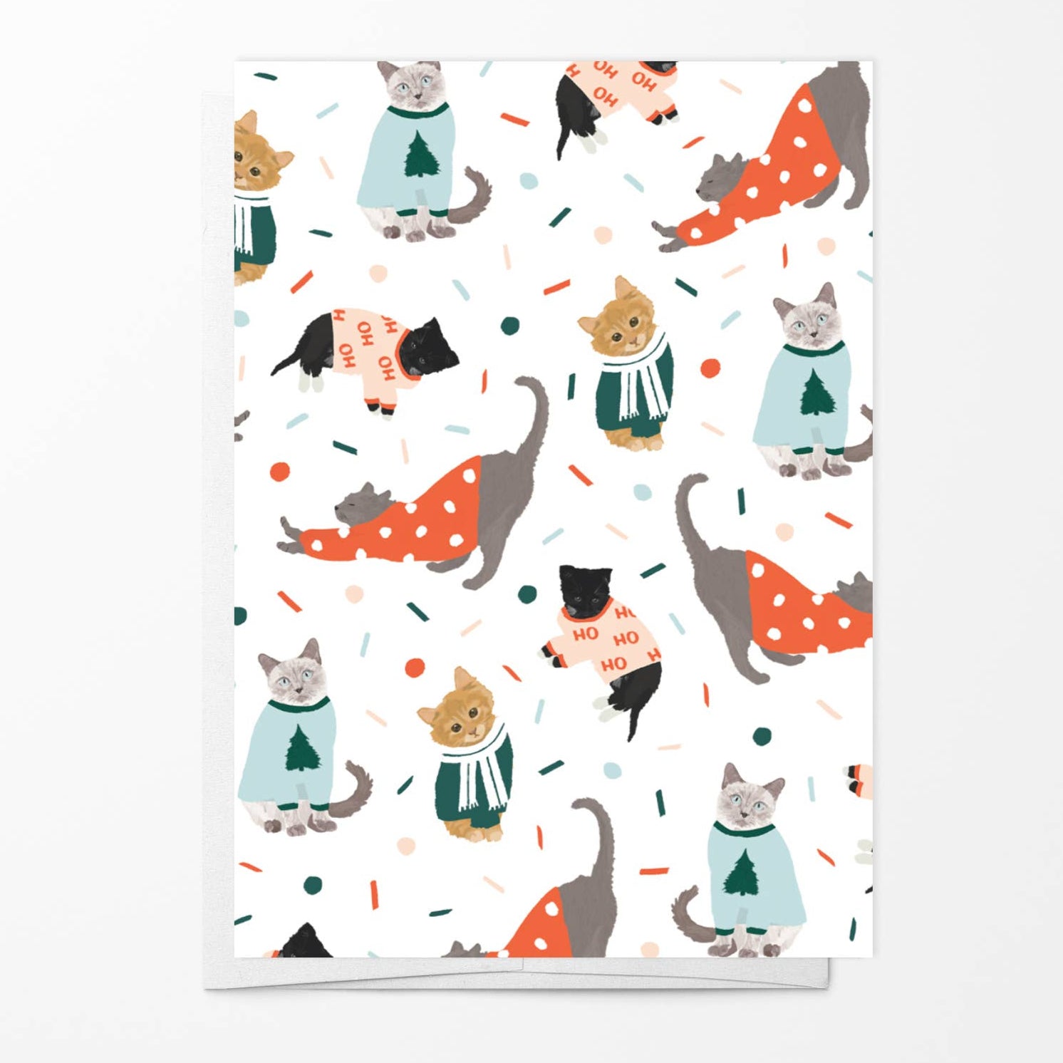 Card with a pattern of cartoon cats in sweaters on a white background