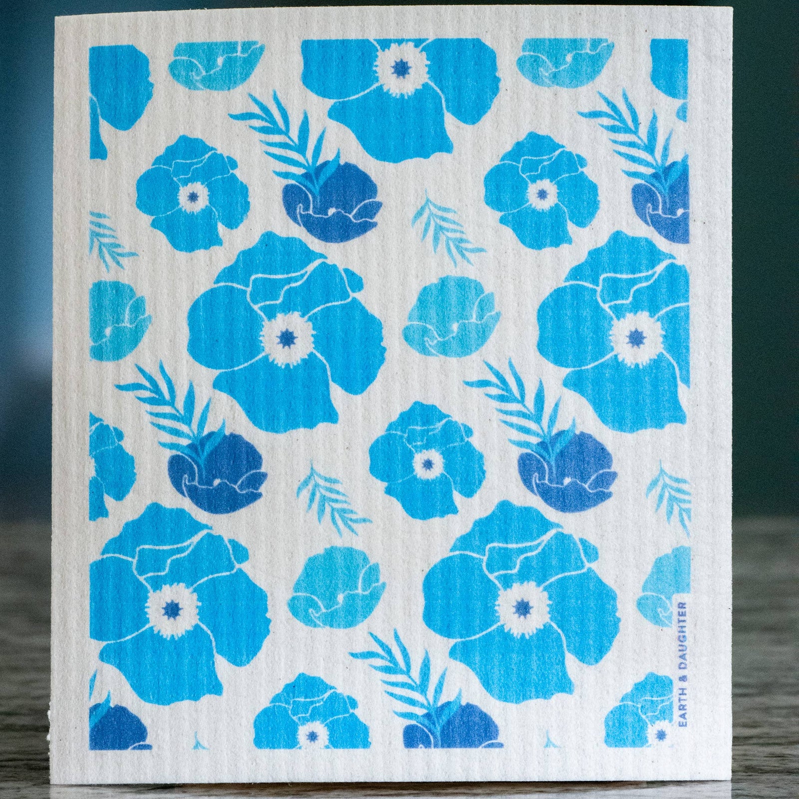 White cloth with blue floral pattern on a wooden surface