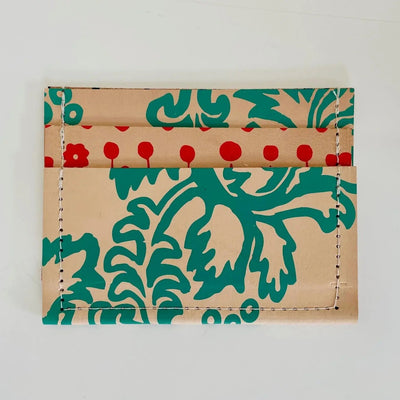 Tan leather wallet with red and turquoise designs on a white background
