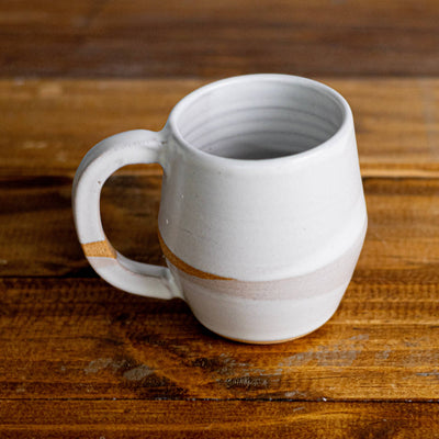 White ceramic mug on a wooden surface