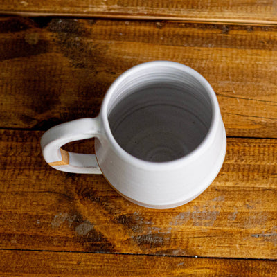 White mug on a wooden surface