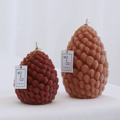 Two textured candles with 'NO CO' labels on a white background