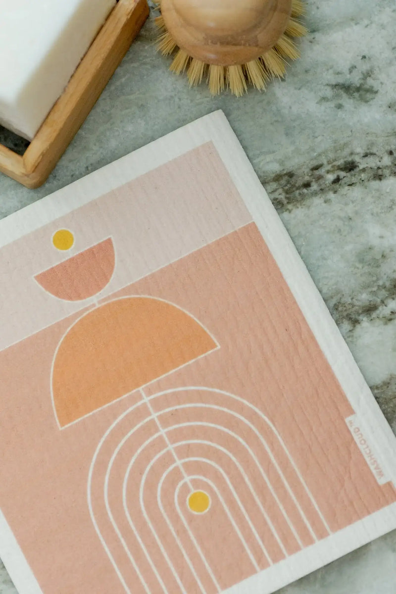 Framed abstract art print on a kitchen counter with a marble backsplash.