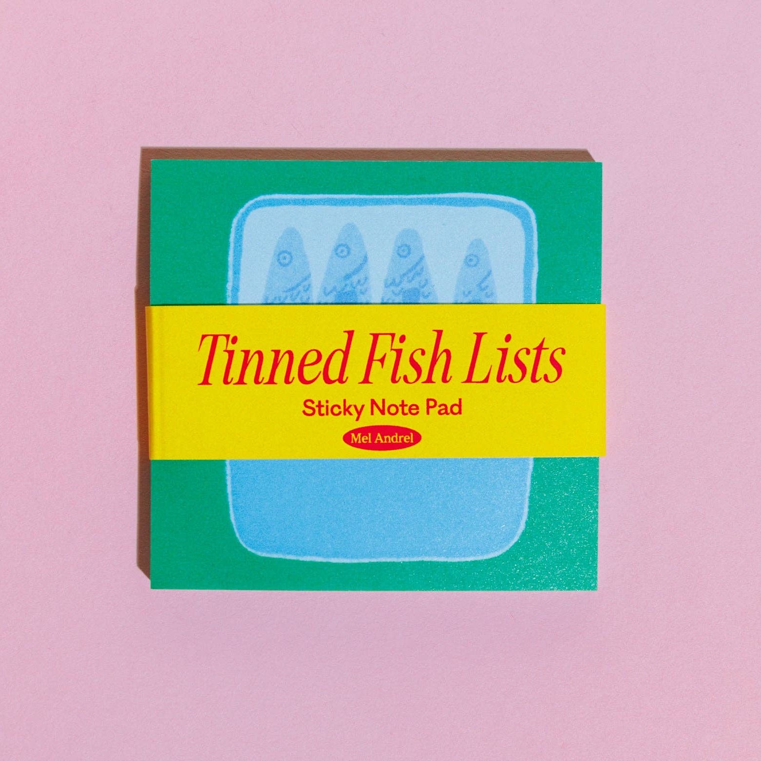Sticky note pad with 'Tinned Fish Lists' on a pink background