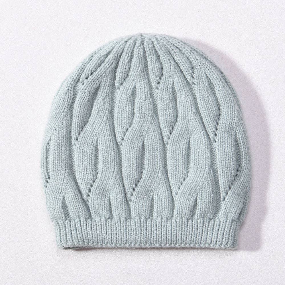 Light blue knitted beanie on a white background