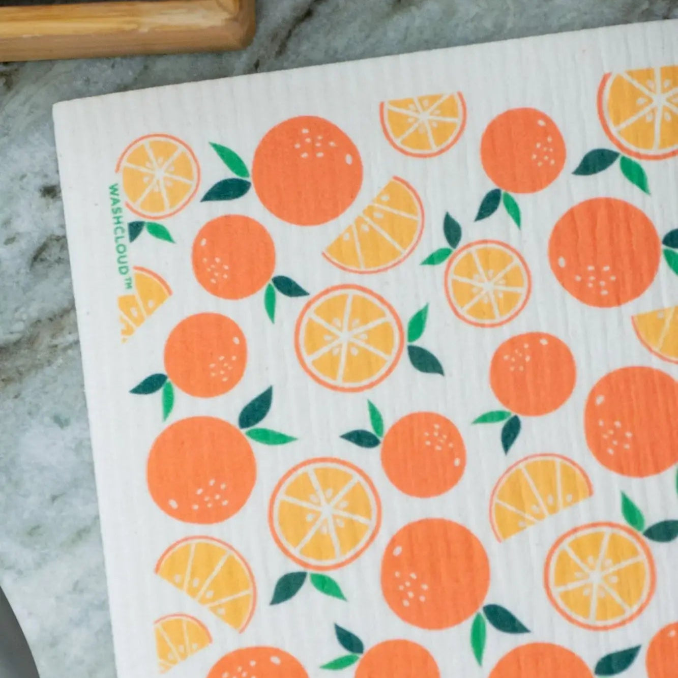 Dishcloth with orange pattern on a marble surface