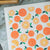 Dishcloth with orange pattern on a marble surface