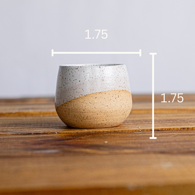 Ceramic match holder with dimensions on a wooden surface