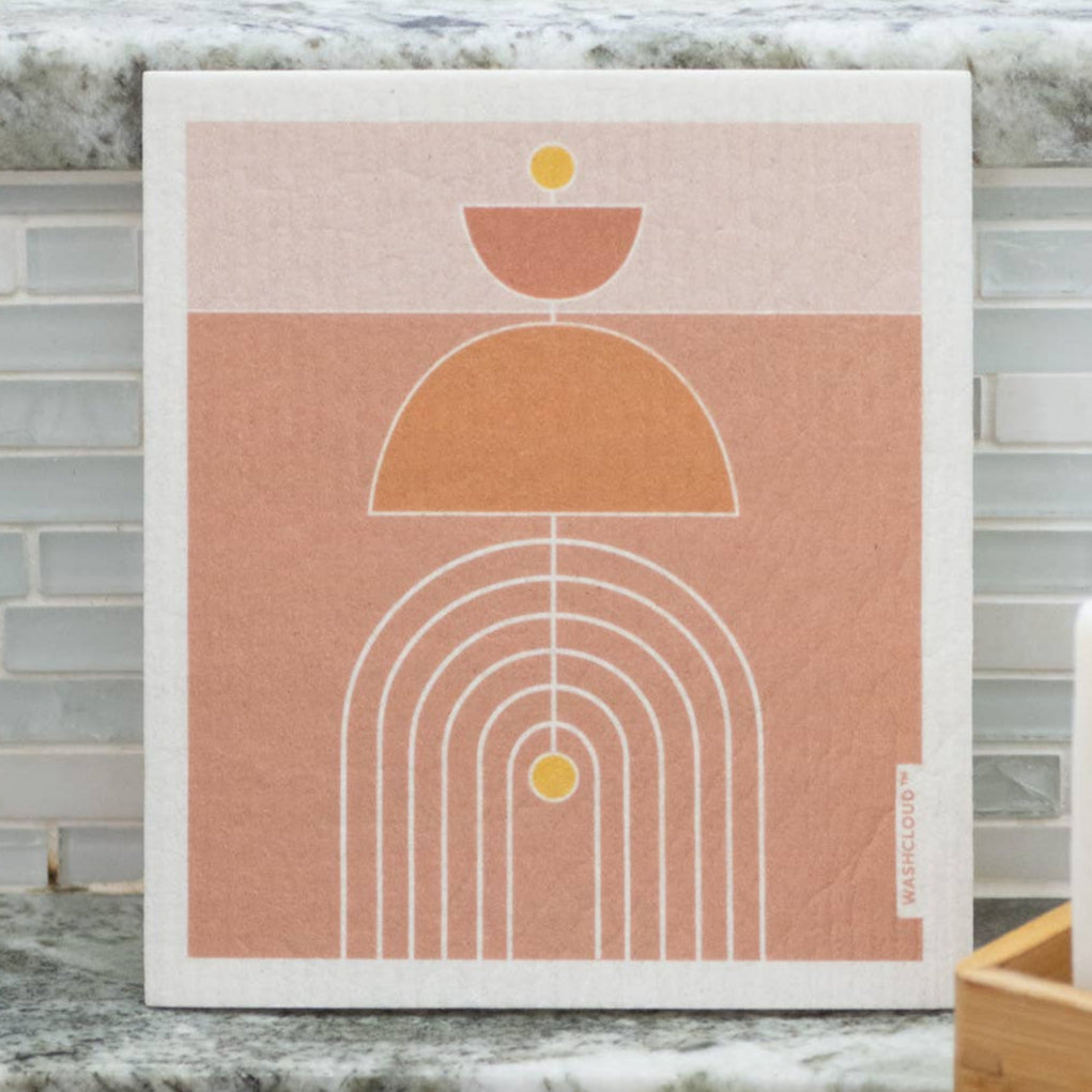 Framed abstract art print on a kitchen counter with a marble backsplash.