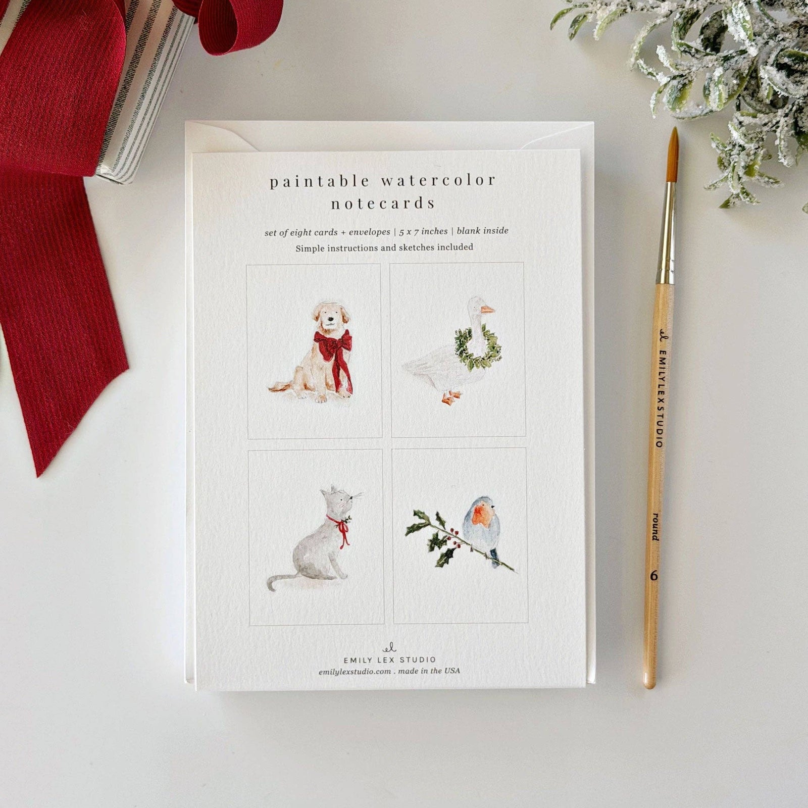 Assorted Christmas animal illustration notecard set on a light background